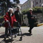 Betty Lou Vickery, 93, who lived on Alcatraz when it was a military prison, walks on a road near the cell block with Ranger John Cantwell and Rita Adams, her granddaughter-in-law, during Vickery's visit to the island.
