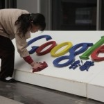 March 22, 2010, a Chinese woman cleans the Google logo outside the Google China headquarters in Beijing, China.